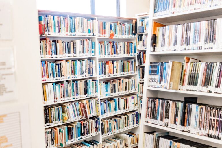 Photo of several shelves full of books, clearly in a library